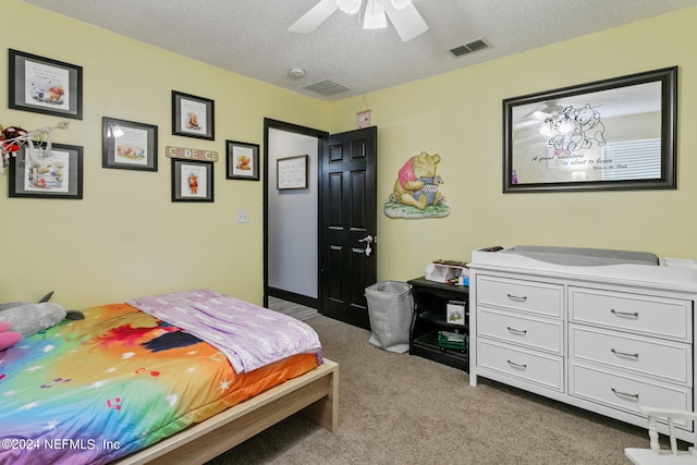 bedroom featuring ceiling fan, a textured ceiling, and light carpet