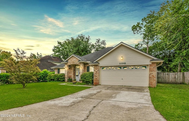 ranch-style home with a lawn and a garage