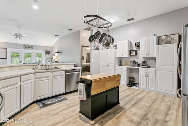 kitchen featuring sink, white cabinetry, light hardwood / wood-style flooring, stainless steel appliances, and ceiling fan