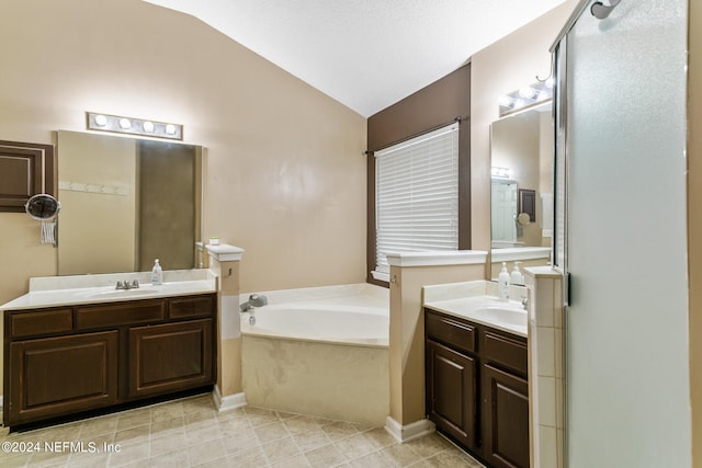 bathroom with shower with separate bathtub, lofted ceiling, vanity, and tile patterned floors