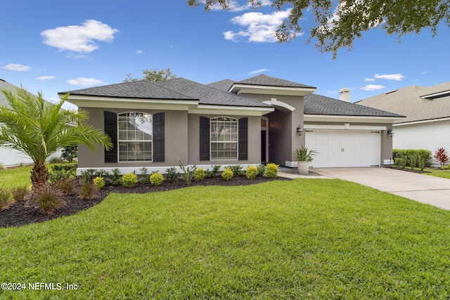 view of front of property featuring a front yard and a garage