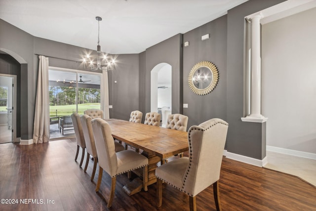 dining area featuring ceiling fan with notable chandelier, dark wood-type flooring, and decorative columns