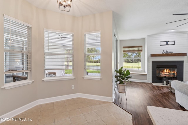 interior space with ceiling fan with notable chandelier