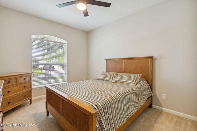 bedroom with ceiling fan and light colored carpet