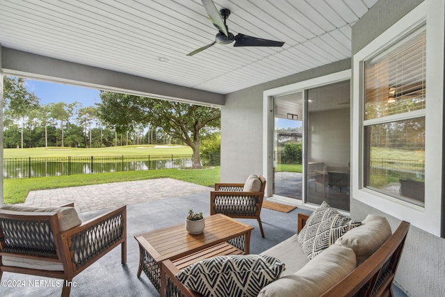 view of patio / terrace with outdoor lounge area, ceiling fan, and a water view