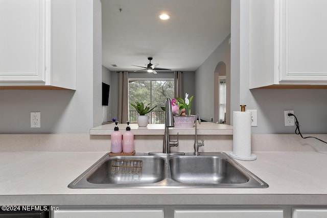 kitchen with ceiling fan, sink, and white cabinetry