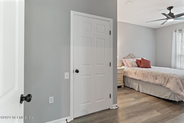 bedroom with light hardwood / wood-style flooring and ceiling fan