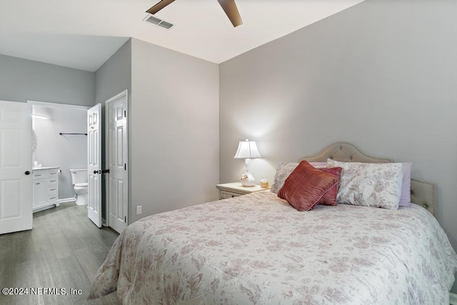 bedroom with dark hardwood / wood-style flooring, ceiling fan, and ensuite bathroom