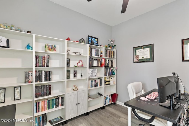 office area with light wood-type flooring and ceiling fan