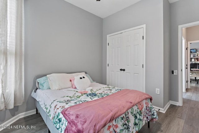 bedroom with a closet and dark hardwood / wood-style flooring