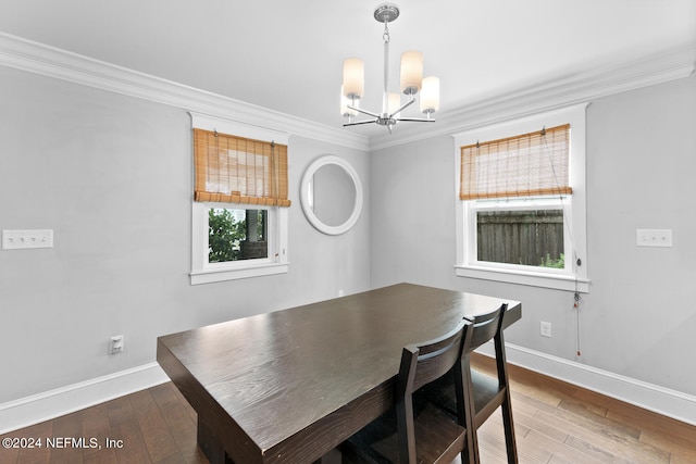 dining room featuring an inviting chandelier, crown molding, and hardwood / wood-style floors