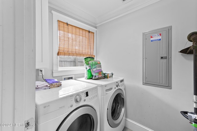 laundry area featuring washer and clothes dryer, ornamental molding, and electric panel