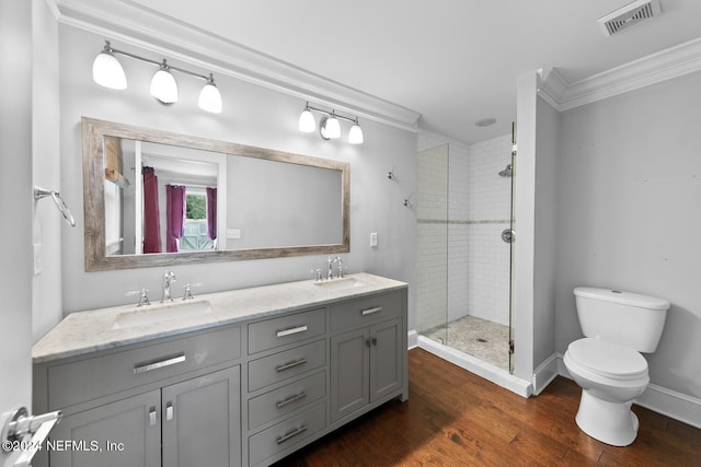 bathroom featuring an enclosed shower, hardwood / wood-style floors, ornamental molding, vanity, and toilet