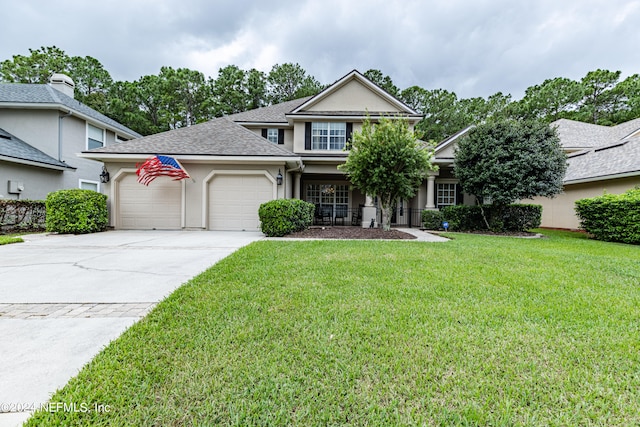 view of front of house with a garage and a front lawn