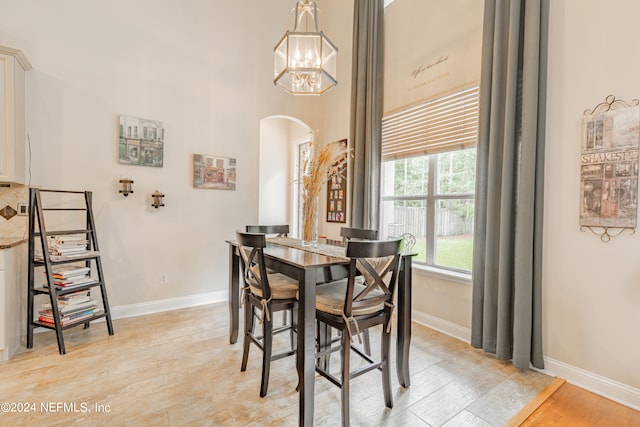 dining area with an inviting chandelier and light wood-type flooring