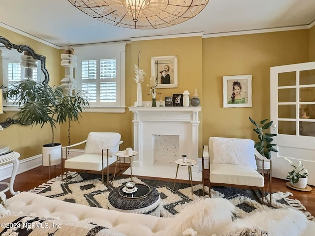 living area with wood-type flooring and ornamental molding