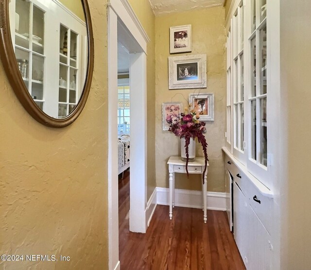 corridor with dark hardwood / wood-style flooring