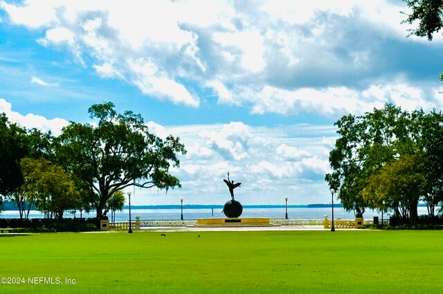 view of property's community featuring a water view and a lawn