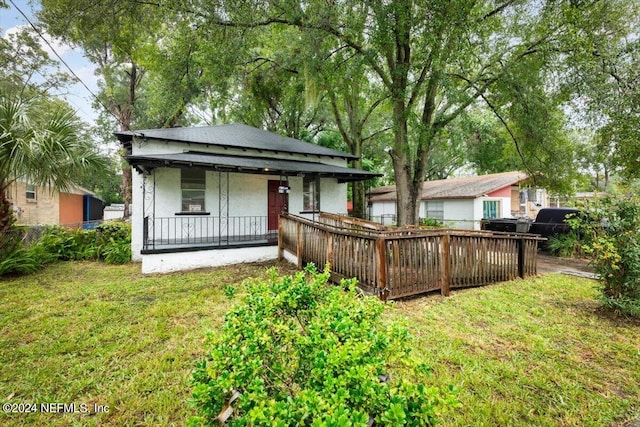 rear view of property featuring a yard