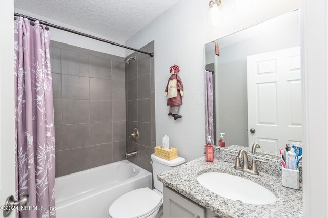 full bathroom with shower / bath combo, a textured ceiling, vanity, and toilet