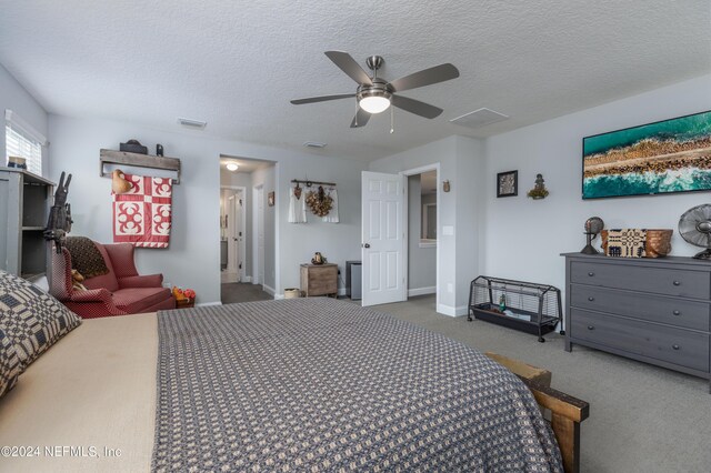 carpeted bedroom with a textured ceiling and ceiling fan