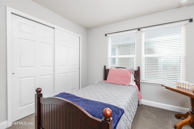 243 Bluejack Ln, Saint Augustine, FL 32095 - carpeted bedroom featuring a closet, multiple windows, a textured ceiling, and baseboards
