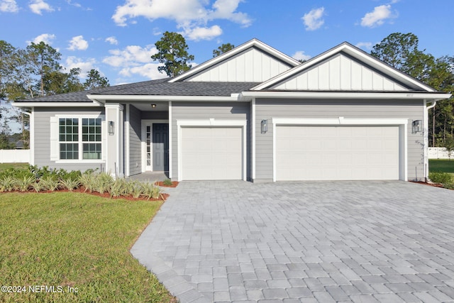 85212 Sandy Ridge Loop Unit 0023, Yulee, FL 32097 - view of front of property featuring an attached garage, a front lawn, decorative driveway, and board and batten siding