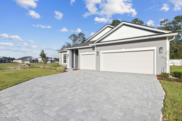 85212 Sandy Ridge Loop Unit 0023, Yulee, FL 32097 - ranch-style home featuring an attached garage, a front yard, decorative driveway, and board and batten siding