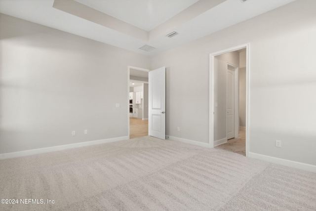 unfurnished bedroom featuring light carpet