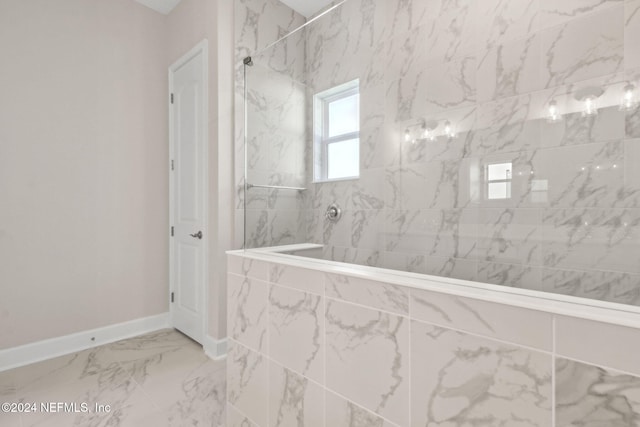 bathroom featuring a tile shower