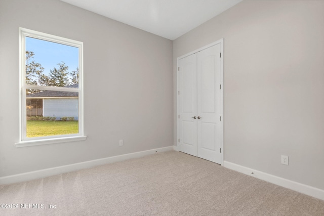 unfurnished bedroom with a closet and carpet