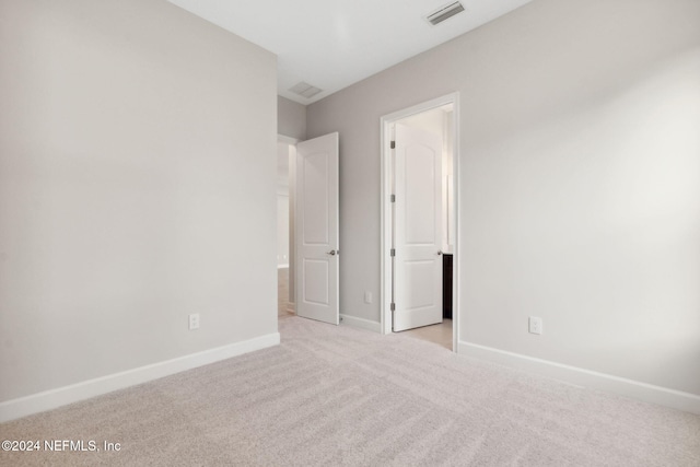 unfurnished bedroom with light colored carpet