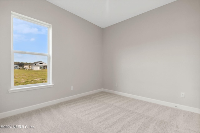 empty room with a healthy amount of sunlight and light carpet