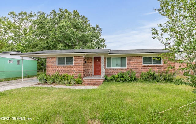 5246 Devron Dr, Jacksonville, FL 32209 - ranch-style house featuring brick siding, concrete driveway, and a carport