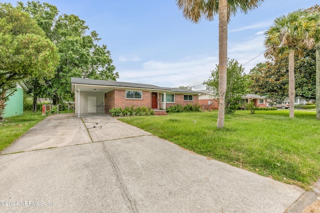 5246 Devron Dr, Jacksonville, FL 32209 - single story home featuring concrete driveway, brick siding, a front yard, and a carport