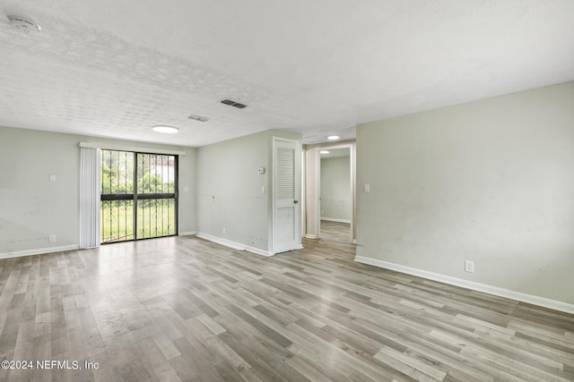 5246 Devron Dr, Jacksonville, FL 32209 - unfurnished room with a smoke detector, baseboards, wood finished floors, and a textured ceiling