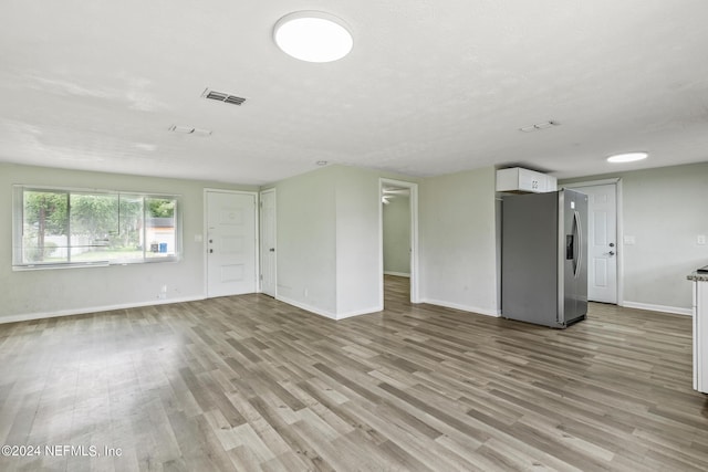 5246 Devron Dr, Jacksonville, FL 32209 - unfurnished living room featuring baseboards and light wood finished floors