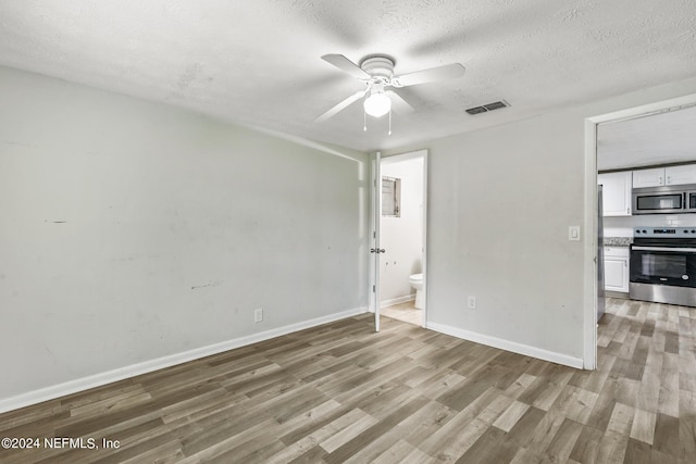 5246 Devron Dr, Jacksonville, FL 32209 - unfurnished room with a ceiling fan, light wood-style flooring, baseboards, and a textured ceiling