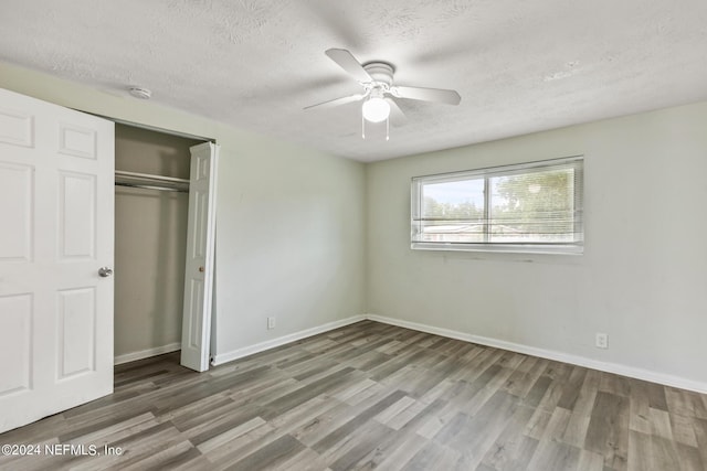 5246 Devron Dr, Jacksonville, FL 32209 - unfurnished bedroom with wood finished floors, a textured ceiling, baseboards, and a closet