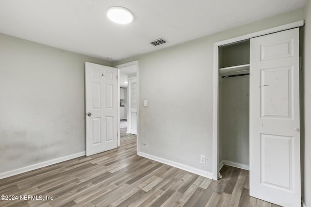 5246 Devron Dr, Jacksonville, FL 32209 - unfurnished bedroom with wood finished floors, baseboards, and a closet