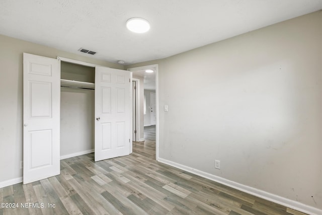 5246 Devron Dr, Jacksonville, FL 32209 - unfurnished bedroom featuring baseboards, wood finished floors, and a closet