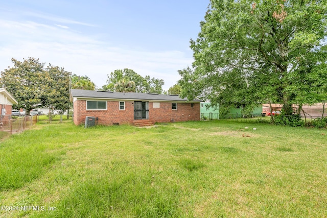 5246 Devron Dr, Jacksonville, FL 32209 - rear view of house with central AC unit, brick siding, and entry steps