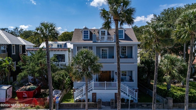 view of front of property with a balcony and covered porch