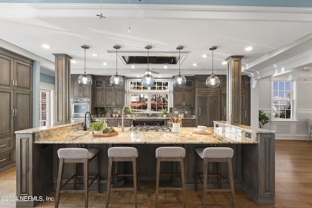 kitchen featuring hanging light fixtures, a breakfast bar area, and a spacious island