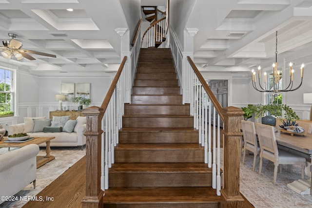 stairway featuring wood-type flooring, ceiling fan with notable chandelier, beam ceiling, and coffered ceiling