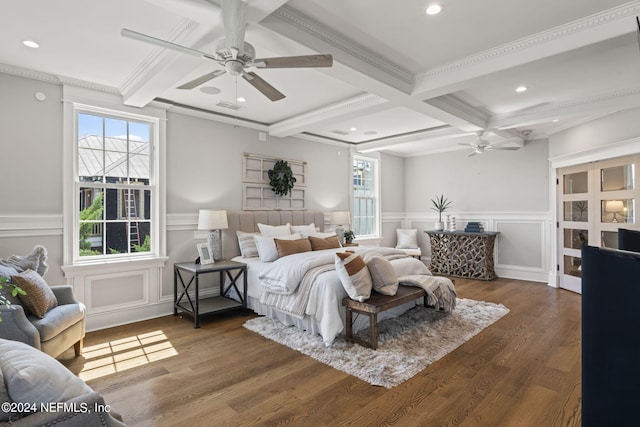 bedroom with beam ceiling, ornamental molding, dark hardwood / wood-style floors, and ceiling fan