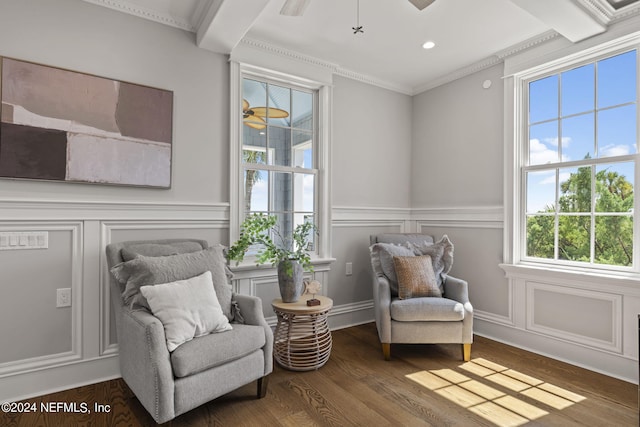 sitting room with beamed ceiling, ornamental molding, dark hardwood / wood-style floors, and ceiling fan