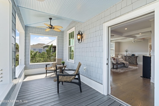 sunroom / solarium with lofted ceiling with beams and ceiling fan