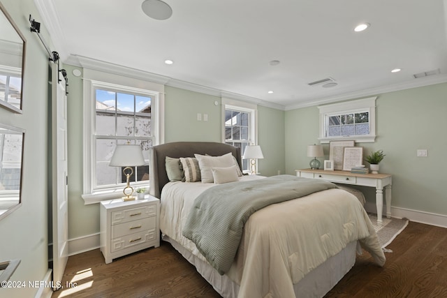 bedroom featuring crown molding, dark wood-type flooring, and a barn door