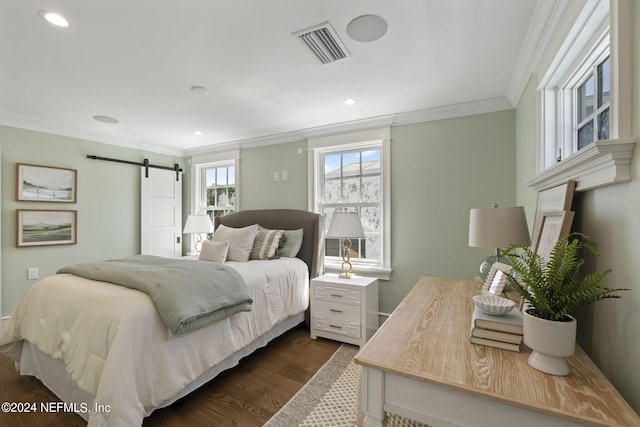 bedroom with a barn door, crown molding, and dark hardwood / wood-style floors